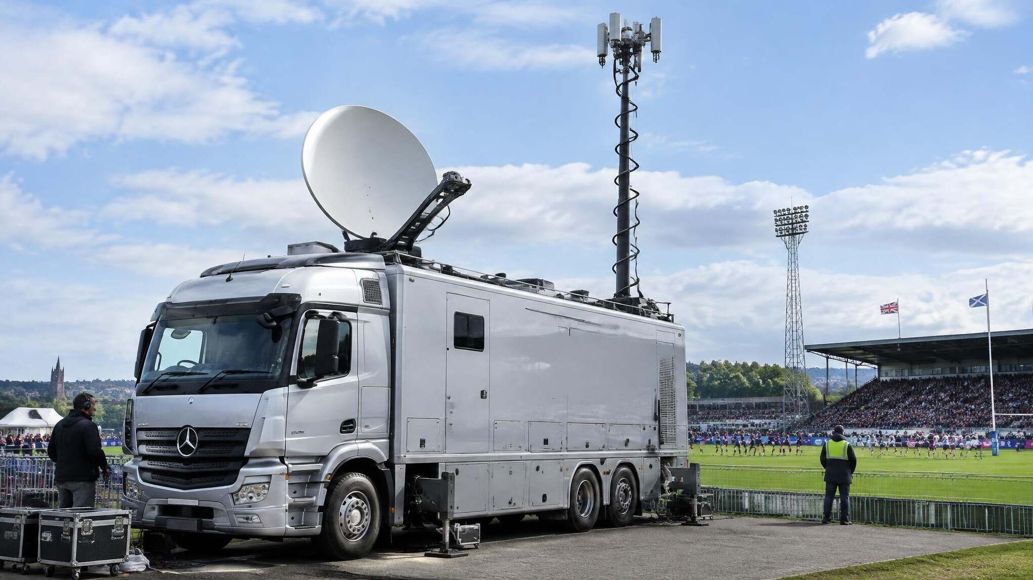 Outside broadcast truck with telescopic mast parked at an event