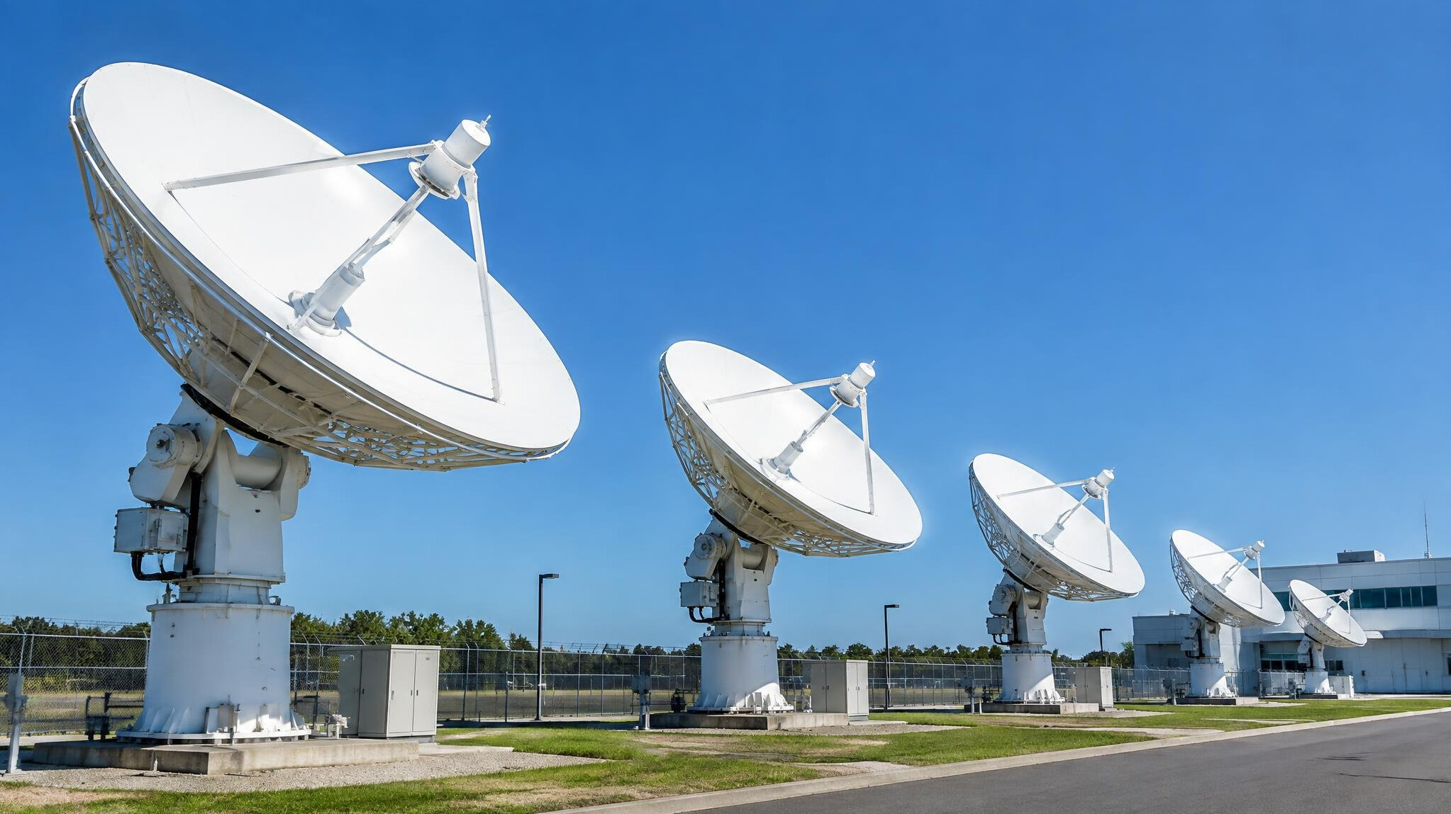 Satellite dishes pointing at the sky at a broadcast uplink facility